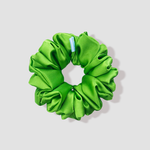 This is a picture of our bright green scrunchie named Zoro. It is a bold green color. The elastic is 8 to 9 inches around. Fun Fact: The name Zoro was inspired by the green hair of the character Zoro in One Piece.