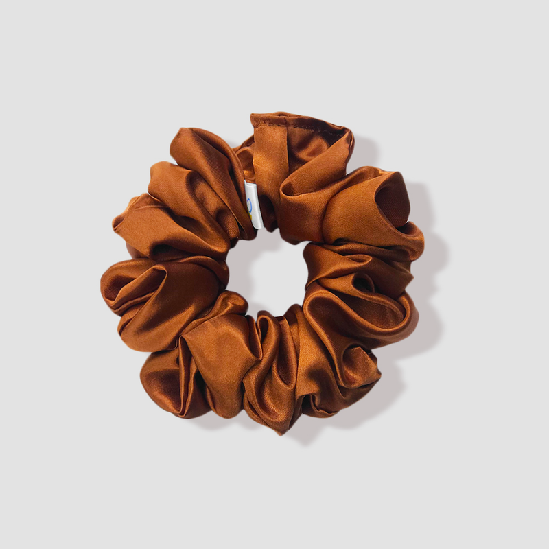 This is a picture of our brown scrunchie named Koper. It has hues of gold and red making it a nice golden-copper color which shines beautifully in sunlight. The elastic is 8 to 9 inches around. Fun Fact: Koper means copper in Danish.
