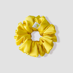 This is a picture of our yellow satin scrunchie named Solèy. It is a beautiful golden yellow color. The elastic is 8 to 9 inches around. Fun Fact: Solèy means Sun in Haitian Kreyòl.
