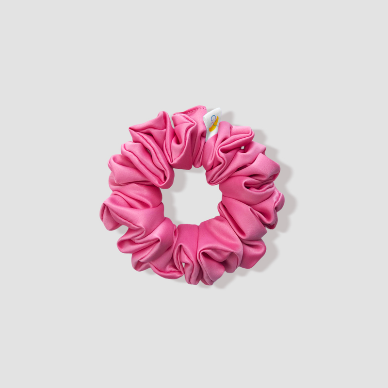 This is a picture of our petite/small matte pink scrunchie named Rossu. It is a beautiful matte solid pink color, not light, not bold, and not shiny. The elastic is 8 to 9 inches around. Fun Fact: Rossu means blush in Corsican.