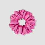This is a picture of our matte pink scrunchie named Rossu. It is a beautiful matte solid pink color, not light, not bold, and not shiny. The elastic is 8 to 9 inches around. Fun Fact: Rossu means blush in Corsican.