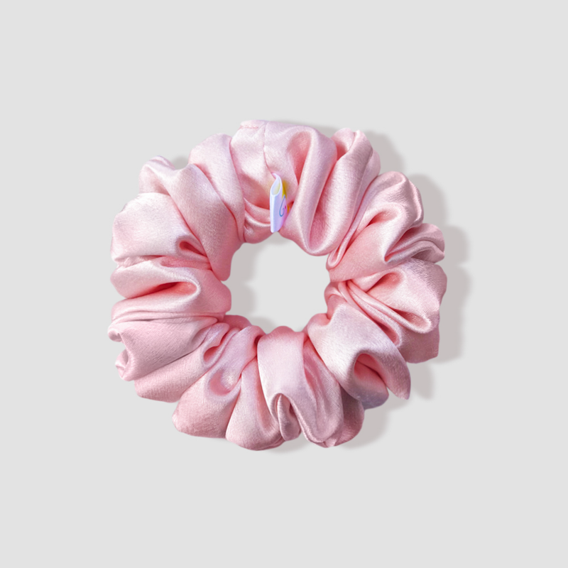 This is a picture of our powder pink scrunchie named Ballet. It is a dreamy pastel pink color. The elastic is 8 to 9 inches around. Fun Fact: Ballet is a French word, and it is a type of performance dance.