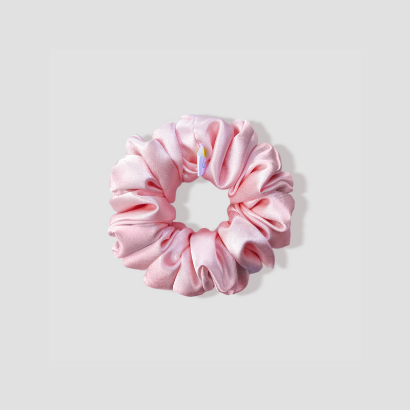 This is a picture of our petite/small powder pink scrunchie named Ballet. It is a dreamy pastel pink color. The elastic is 8 to 9 inches around. Fun Fact: Ballet is a French word, and it is a type of performance dance.