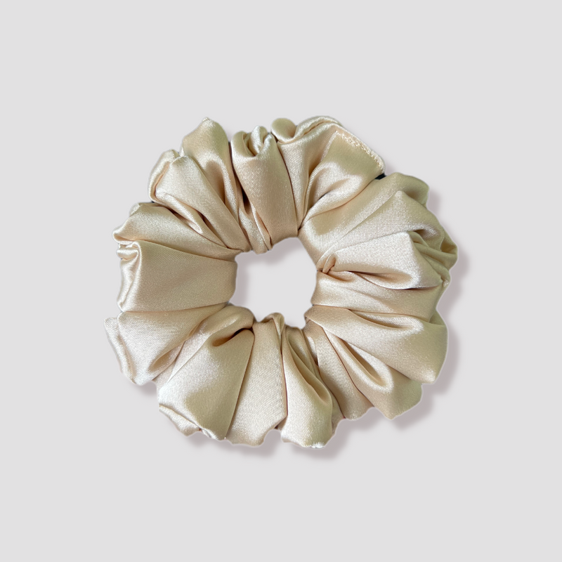 This is a picture of our beige scrunchie named Champagne. It is a beautiful pale, sandy color, a perfect addition to your neutral collection. The elastic is 8 to 9 inches around. Fun Fact: This beige color was inspired by bubbly champagne.
