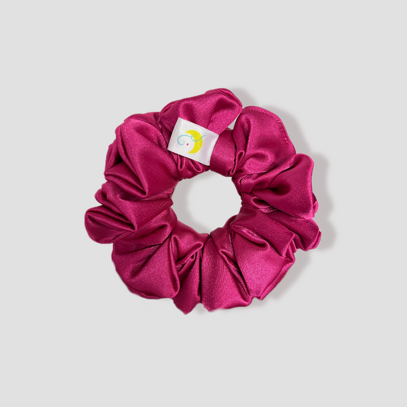 This is a picture of our magenta scrunchie named Fleur. It is a vibrant pink color. The elastic is 8 to 9 inches around. Fun Fact: Fleur means flower in French.