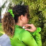 Picture of the Bright Green colored scrunchie in the hair and on the wrist