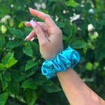 Picture of the Turquoise/Light Teal colored scrunchie on the wrist