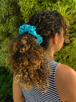 Picture of the Turquoise/Light Teal colored scrunchie in the hair