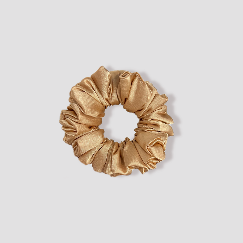 This is a picture of our small sized light brown scrunchie named Latte Petite. It is a nice neutral color. The elastic is 8 to 9 inches around. Fun Fact: Latte was inspired by the color of a mocha latte Frappuccino.